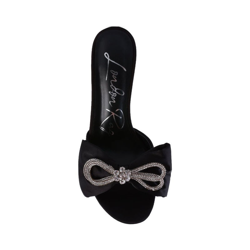 brag in rhinestone embellished bow satin heels.